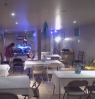 Event hall set up with white linen tables and chairs