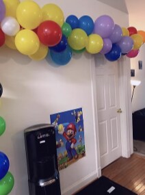 Colorful balloon arch around a doorway for a Super Mario party