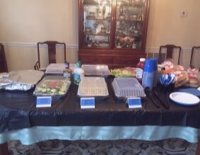 Buffet table dressed in black and light blue linens