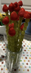 Veggie tray with ranch dip above a fruit platter shaped like a baby face