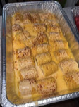 Pan of baked rolls in a golden sauce