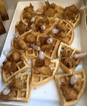 Chicken and waffle bites on a white platter