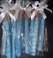 Blue chocolate-dipped pretzel rods wrapped with white bows