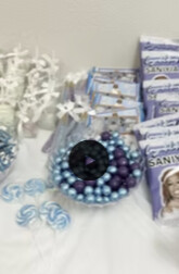 Blue and silver candy table with lollipops and custom wrapped treats