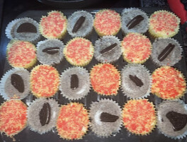 Cupcakes topped with Oreo cookies and colorful sprinkles