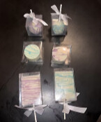 Individually boxed cake pops and treats tied with white ribbon